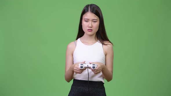 Young Beautiful Asian Businesswoman Playing Games