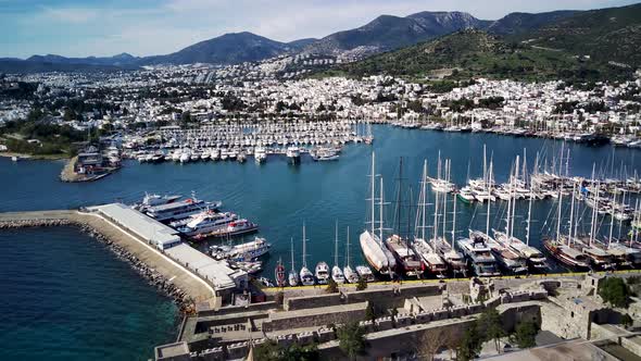 Amazing panoramic view from drone of full of yachts Bodrum harbour and ancient Kalesi castle. alt