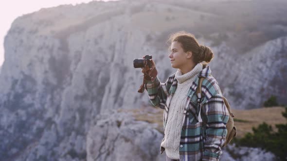 Woman Tourist Photos Distant Old Mountains with Camera