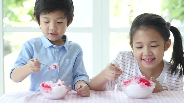 Happy Little Asian Children  Eating Ice Cream At Home alt