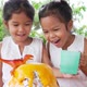 Two girls do volcano experiment at their house - VideoHive Item for Sale