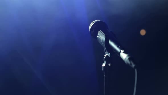 Closeup of Microphone on Stage in the Dark alt