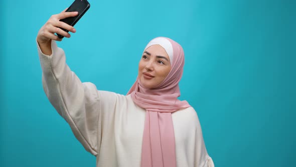 Young Muslim Woman in Hijab Taking Selfie