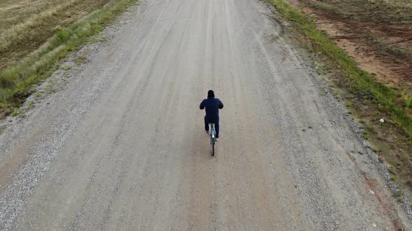 cycling road bike, bicycle rider from top, aerial view, shot from above, man cyclist on empty road