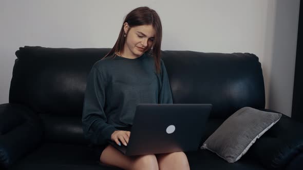 The Redhaired Freckled Young Woman Smiles a Message in Response Caught in a Conversation with a Good alt