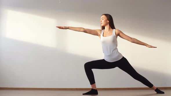 Young Adult Female Doing Yoga at Home.