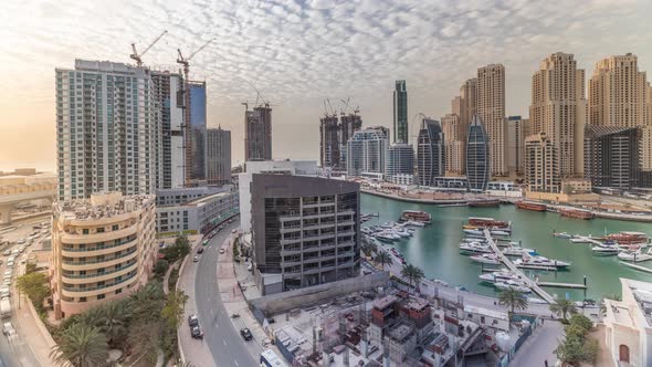 Yachts in Dubai Marina Flanked By the Al Rahim Mosque and Residential Towers and Skyscrapers Aerial alt