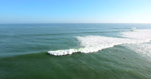 Flying out over surfers at C Street surf spot in Ventura, California