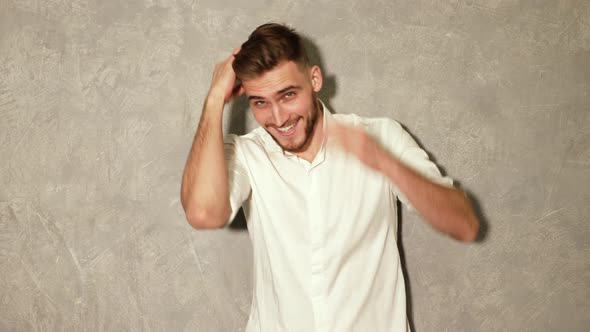 Portrait of attractive bearded stylish young man looking into the camera and smiling alt