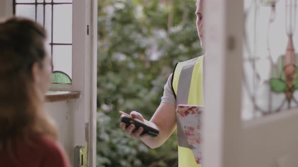 Adult woman receiving Valentine's day gift from delivery man