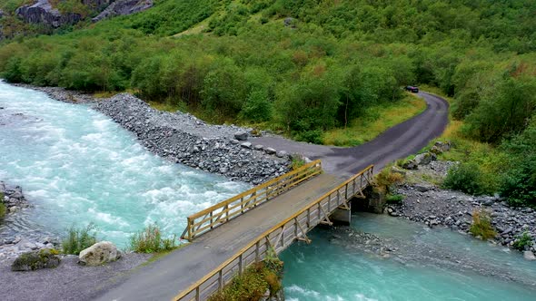 Bridge over a beautiful gushing river in a forest alt