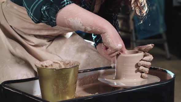 Pottery Crafting  Woman Hands Forms Clay in the a Small Simple Pot Shape alt
