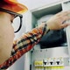 Young Adult Electrician Builder Engineer Checking Equipment in Fuse Box - VideoHive Item for Sale