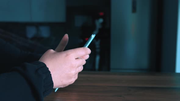 Hands of Woman Using the Phone at Home Closeup Writes SMS Surfs the Internet Moving Camera alt