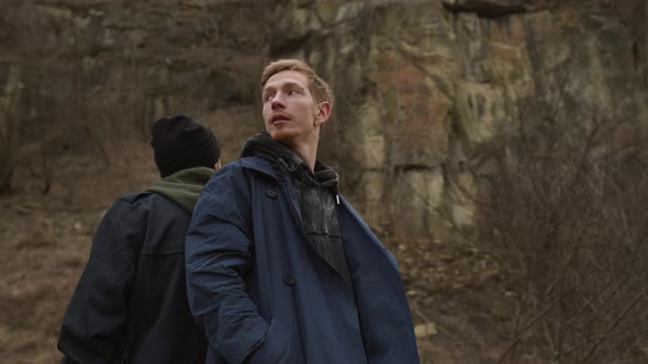 Two Young Guys Walking On The Road In Nature. They Joke And Laugh. alt