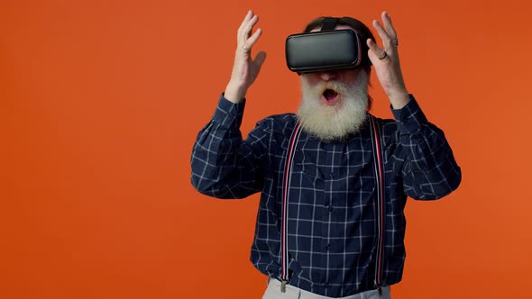 Elderly Stylish Grayhaired Man Using Headset Helmet App to Play Simulation Virtual Reality VR Game alt