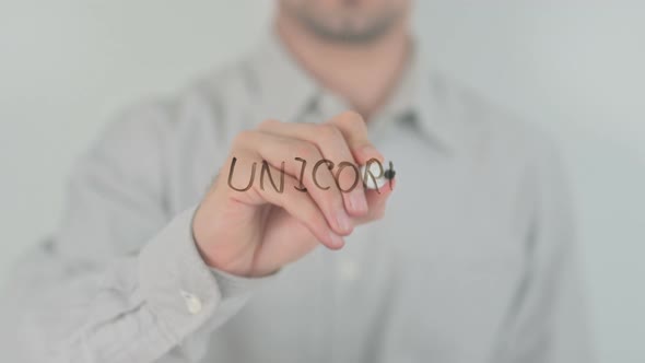 Unicorn Writing on Screen with Hand alt