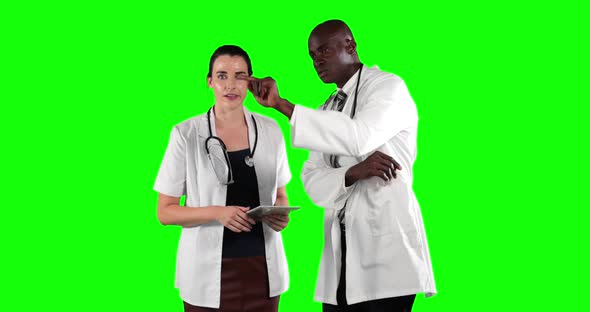 a Caucasian and African American people wearing a surgeon blouse and scrumbs in a green