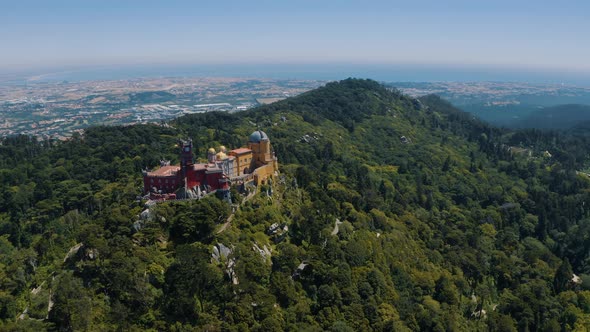 Drone footage of Pena Palace and National Park in Sintra, The Colorful Ancient Castle, Portugal 4K