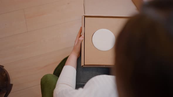 Woman Designer Open Box or Parcel to Checking Packaging of New Product  Jewellery Box  Top View alt