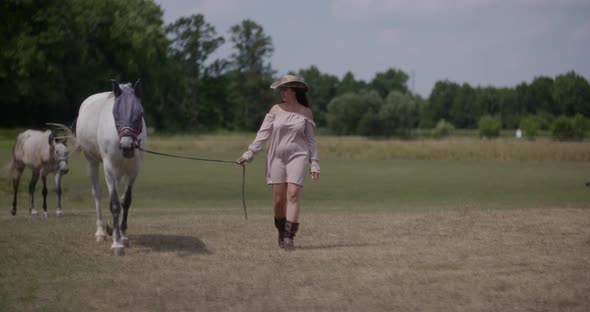Woman Riding Horse on Farm, Recreation, Woman Walking with Horse alt
