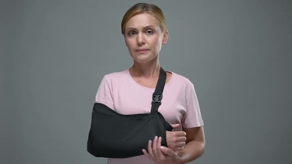 Upset Woman With Arm Sling Looking Into Camera, Fracture or Sprain, Trauma