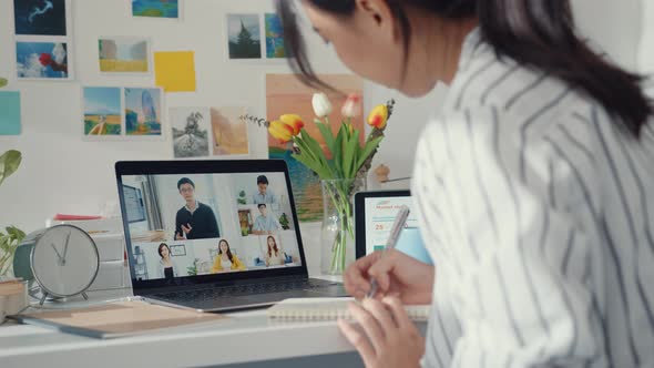 Young asia female employee listen leader on video call with diverse multiracial colleagues on online