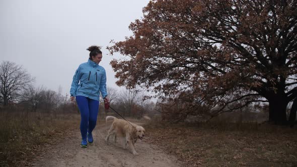 Pretty Fitness Woman and Dog Jooging in Fresh Air alt