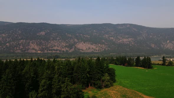 British Columbia BC Canada Travel Drone Footage of Mountain, Trees, and Lakes During Wildfire alt