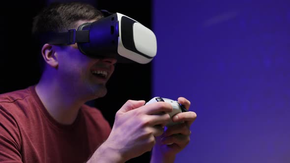 Attractive Caucasian Man Hold Joystick and Wear Virtual Reality Glasses Headset on Weekend