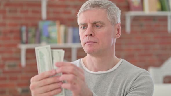 Wise Senior Old Man Counting Dollars alt