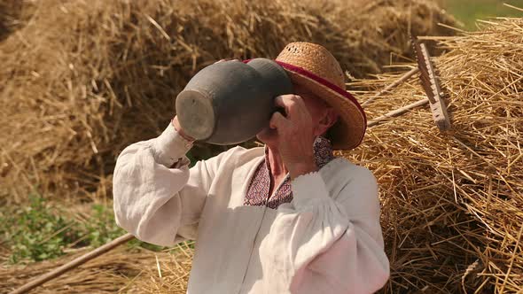 Thirsty Old Man Grandpa Drinks Water From Jug alt