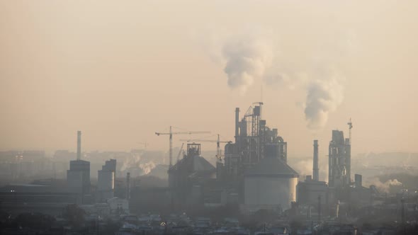 Cement Plant with High Factory Structure and Tower Cranes at Industrial Production Area alt