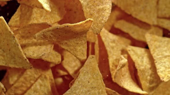 Super Slow Motion Shot of Tortilla Chips Flies After Being Exploded on Black Background 1000Fps alt