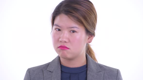 Face of Serious Young Asian Businesswoman Nodding Head No alt