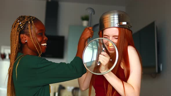 Mixed Race Couple Struggling with a Saucepan on My Head Kitchen alt