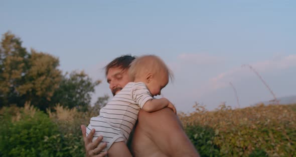 Cute Little Child and Father Man Having Fun Together Tossing Up Throwing Son alt