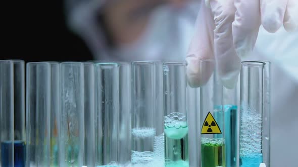 Scientist in Uniform Taking Radioactive Liquid in Tube, Dangerous Emission, Lab alt