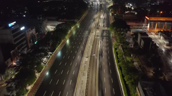Low Flying Aerial Tilting Dolly Shot of Empty Multi Lane Road in Modern City Center with Skyscrapers alt
