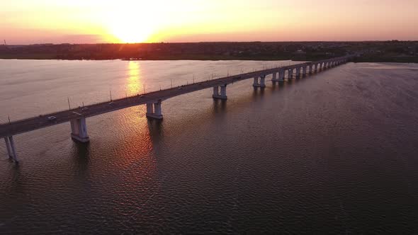 Aerial Shot of an Outstretched Bridge Over the Dnipro at a Nice Sunset in Summer