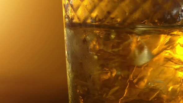 Ice cubes in a glass with whiskey