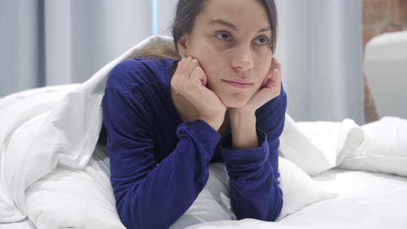 Thinking Hispanic Woman in Bed Daydreaming, Brainstorming alt