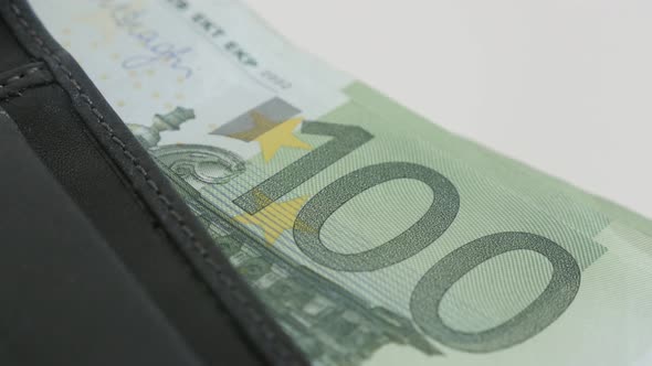Wad of 100 euro banknotes in bi-fold money case 3840X2160 UltraHD tilting footage - Money in black l