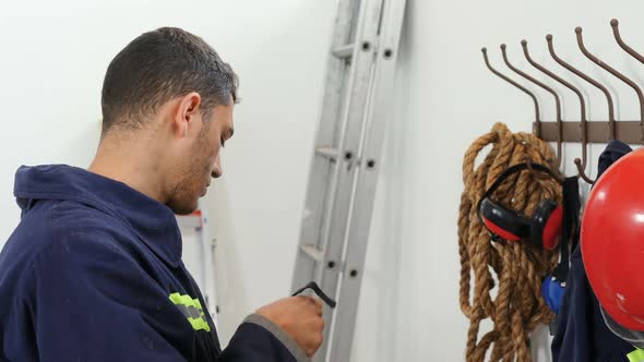 Fireman putting the safety helmet on the hook 4k alt