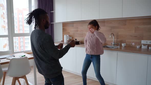 Active Happy African American Family Jumping Dancing and Having Fun at Home alt