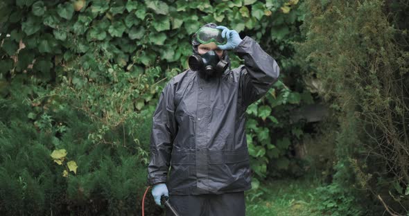 Man in Chemical Protection Suit Respirator and Glasses Medium Shot