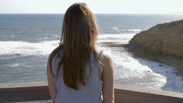 Rear view of young woman looking at sea, Victoria , Australia