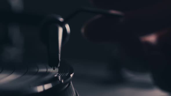 Male Hand Put Needle on Record Spinning on Turntable alt