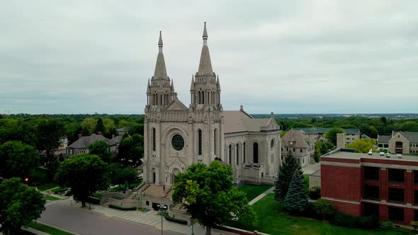 Majestic well maintained church building with lush green landscaping surrounding the site.