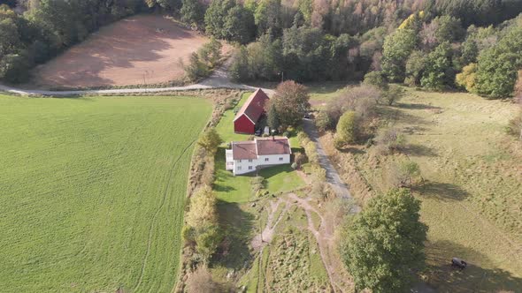 Traditional Swedish Farm White House and Red Barn Aerial Forward